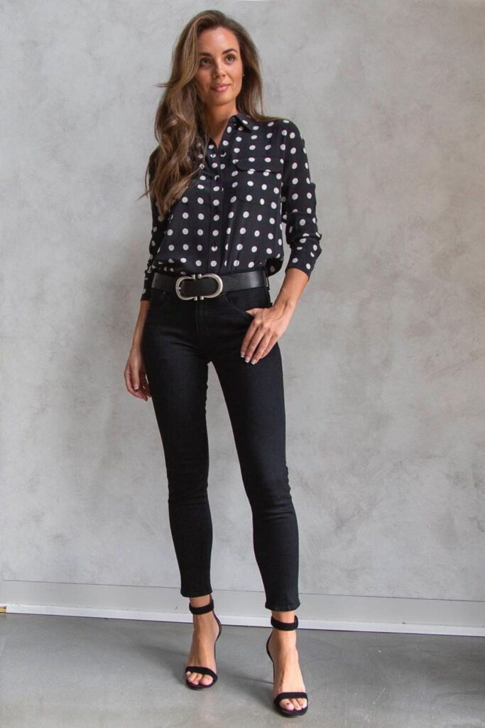 person wearing black pants and polka dot shirt