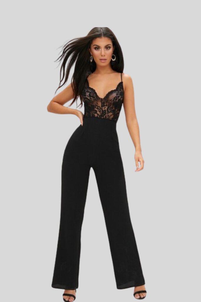 Model wearing black wide leg lace jumpsuit with black block heel sandals