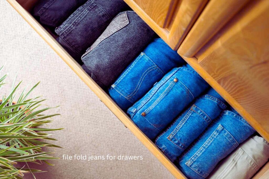 jeans folded into vertical rectangles standing in drawer