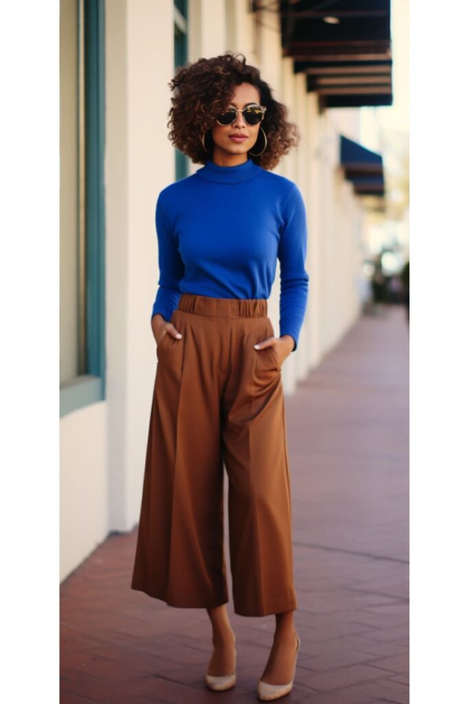 woman wearing a royal blue sweater with brown culottes and matching heels