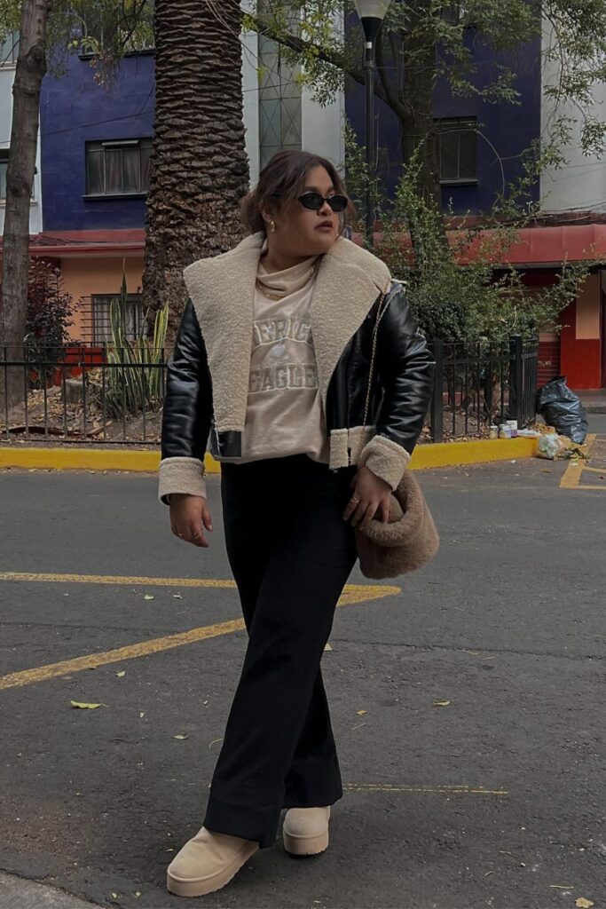 Black Leather Jacket, Beige Graphic Tee, and Black Wide-Leg Pants