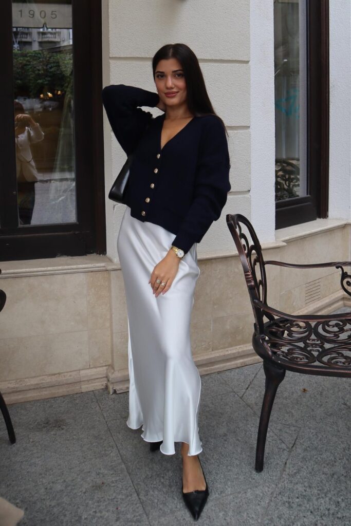 Black Cardigan With a Satin Skirt and Pointed Pumps