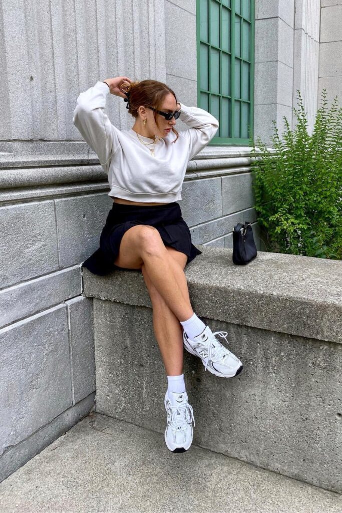 Cropped Sweatshirt, Black Skirt and White Sneakers