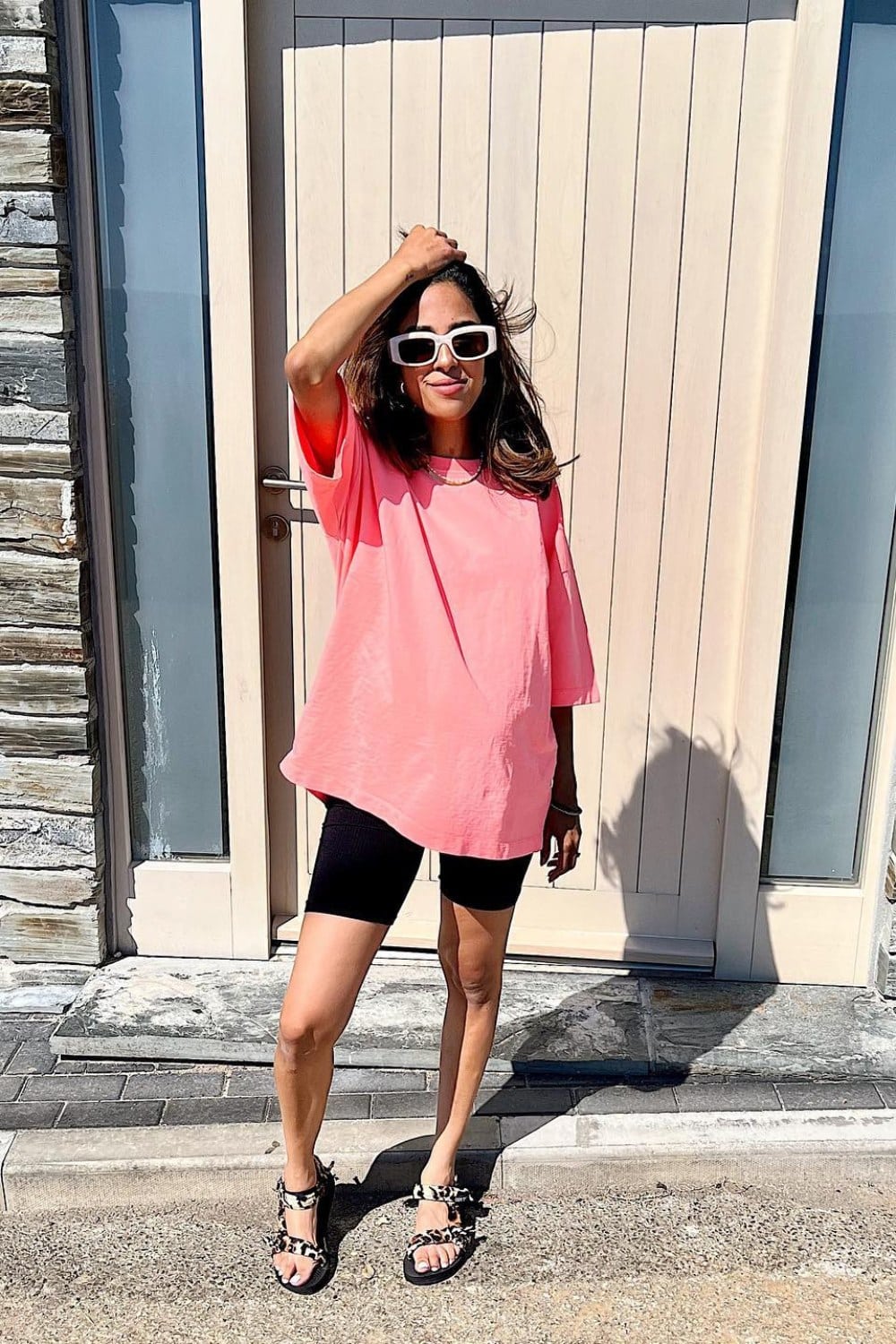 Oversized Pink T-Shirt, Black Biker Shorts, and Black Sandals