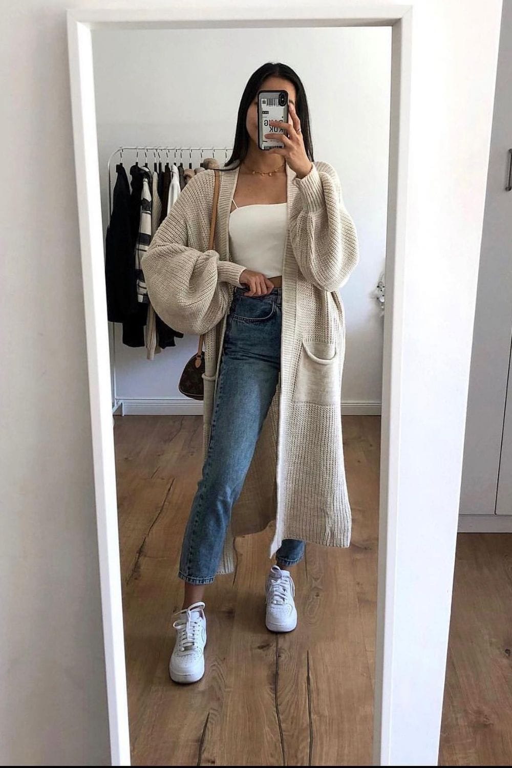 Long Cream Knit Cardigan, White Camisole, and Light Wash Jeans