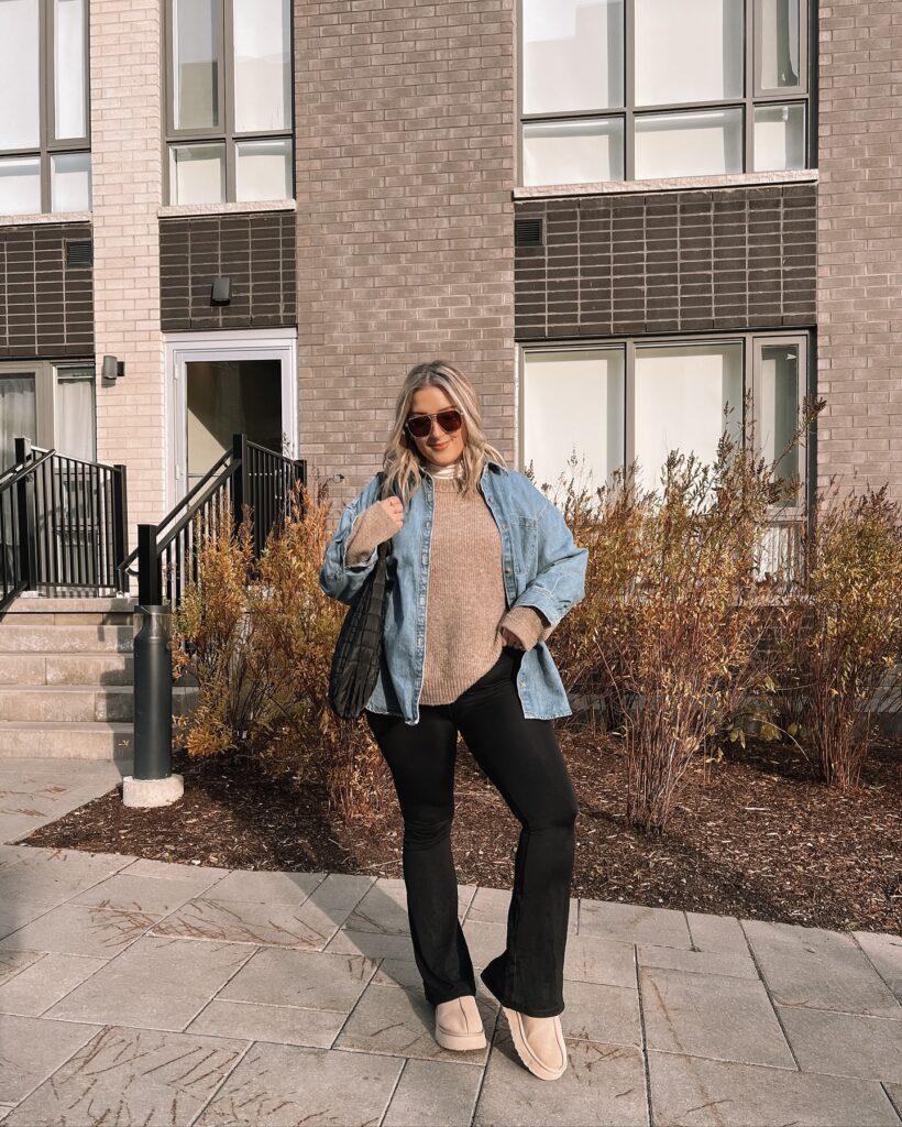 Beige turtleneck under an oversized denim shirt with black flared leggings and tan platform mini boots