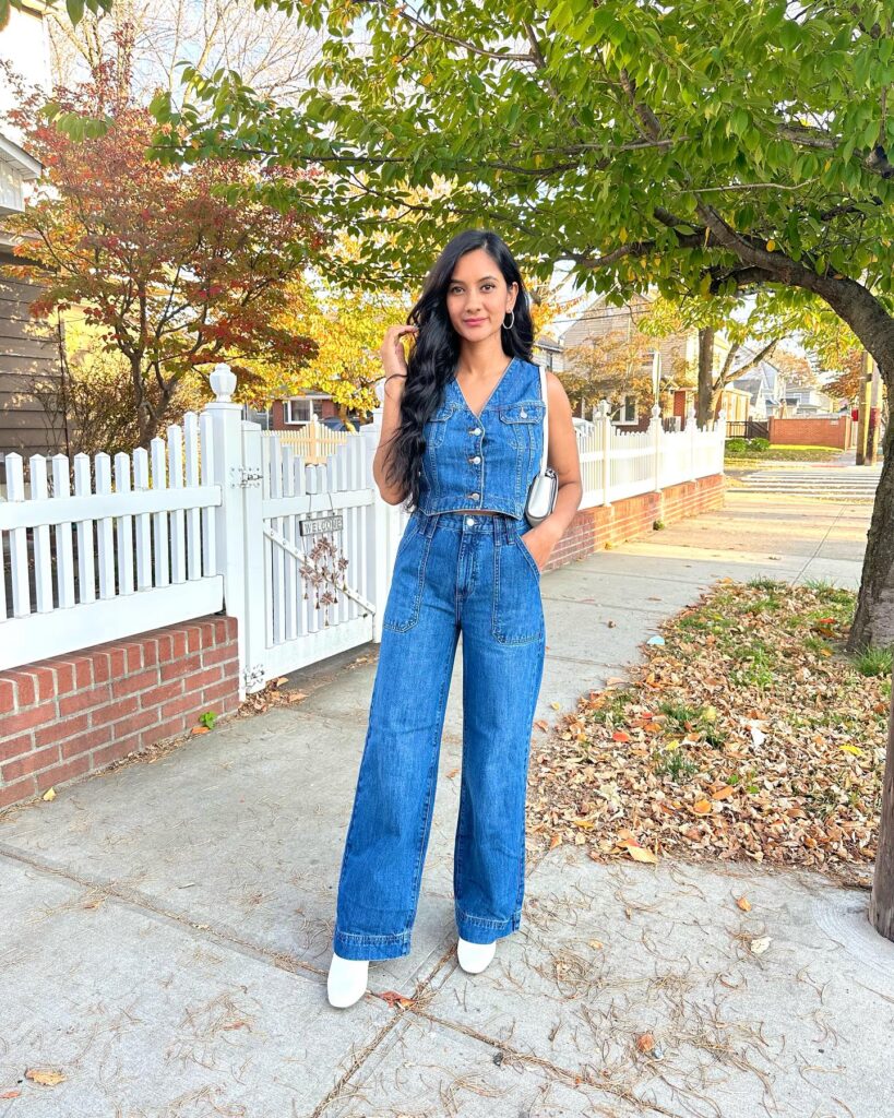 Denim vest and wide-leg jeans in matching mid-wash denim with white ankle boots and a silver bag