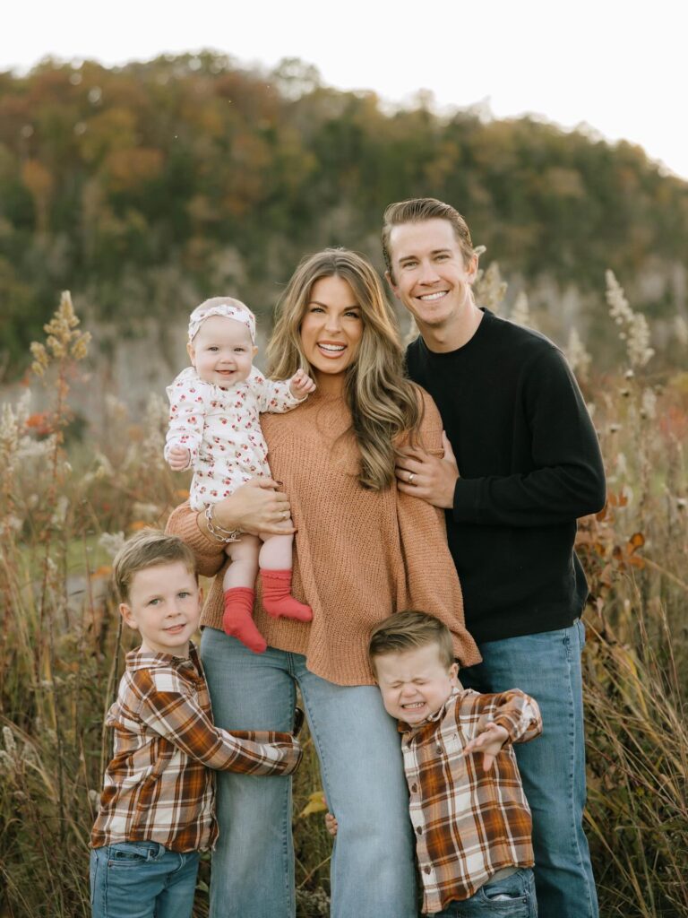 Family of five in a field, mom in camel knit