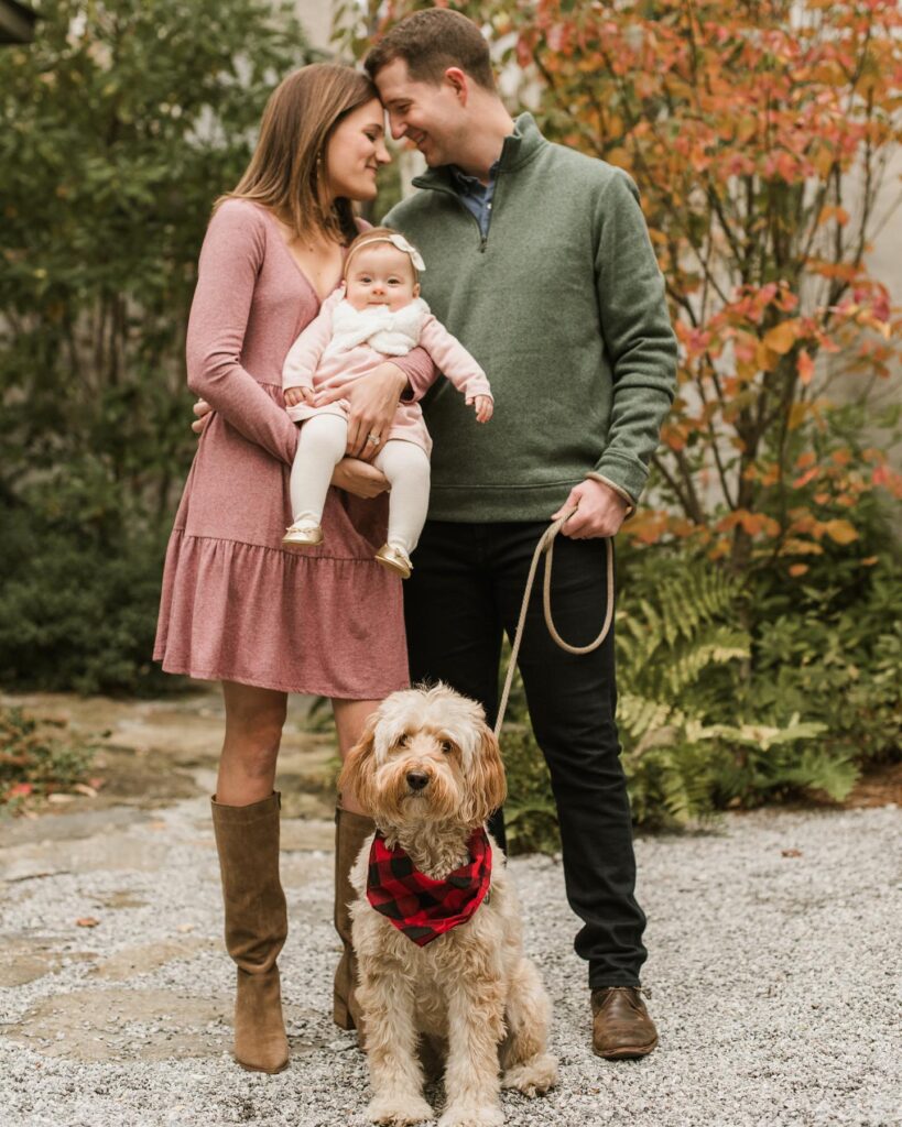 Couple with baby and dog, mom in mauve, dad in green
