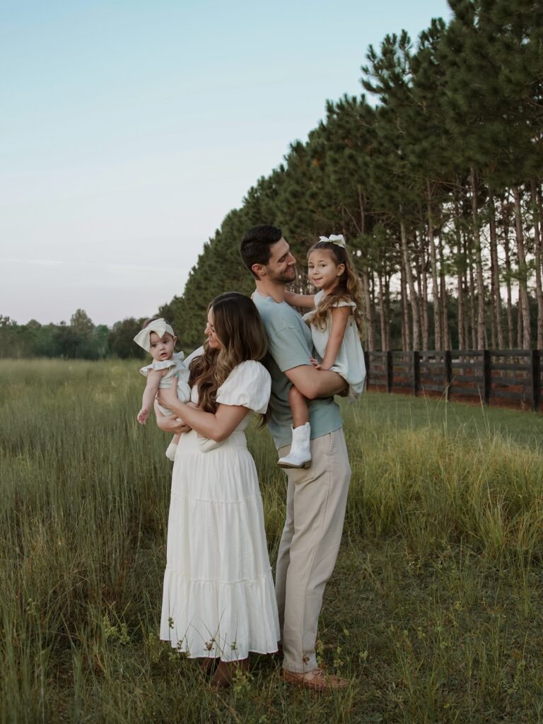 Family in a pine field, sage and cream