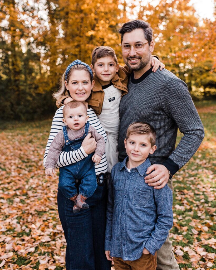 Family in fall leaves, mom in breton stripes