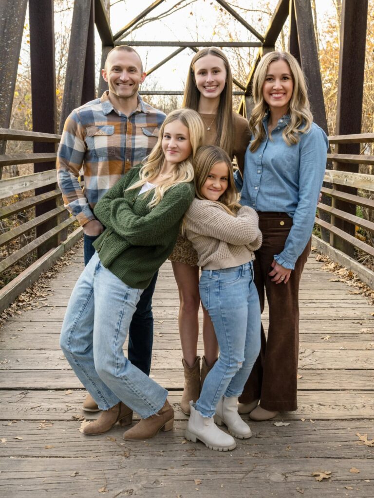 Family of five on a bridge, dad in blue-brown plaid