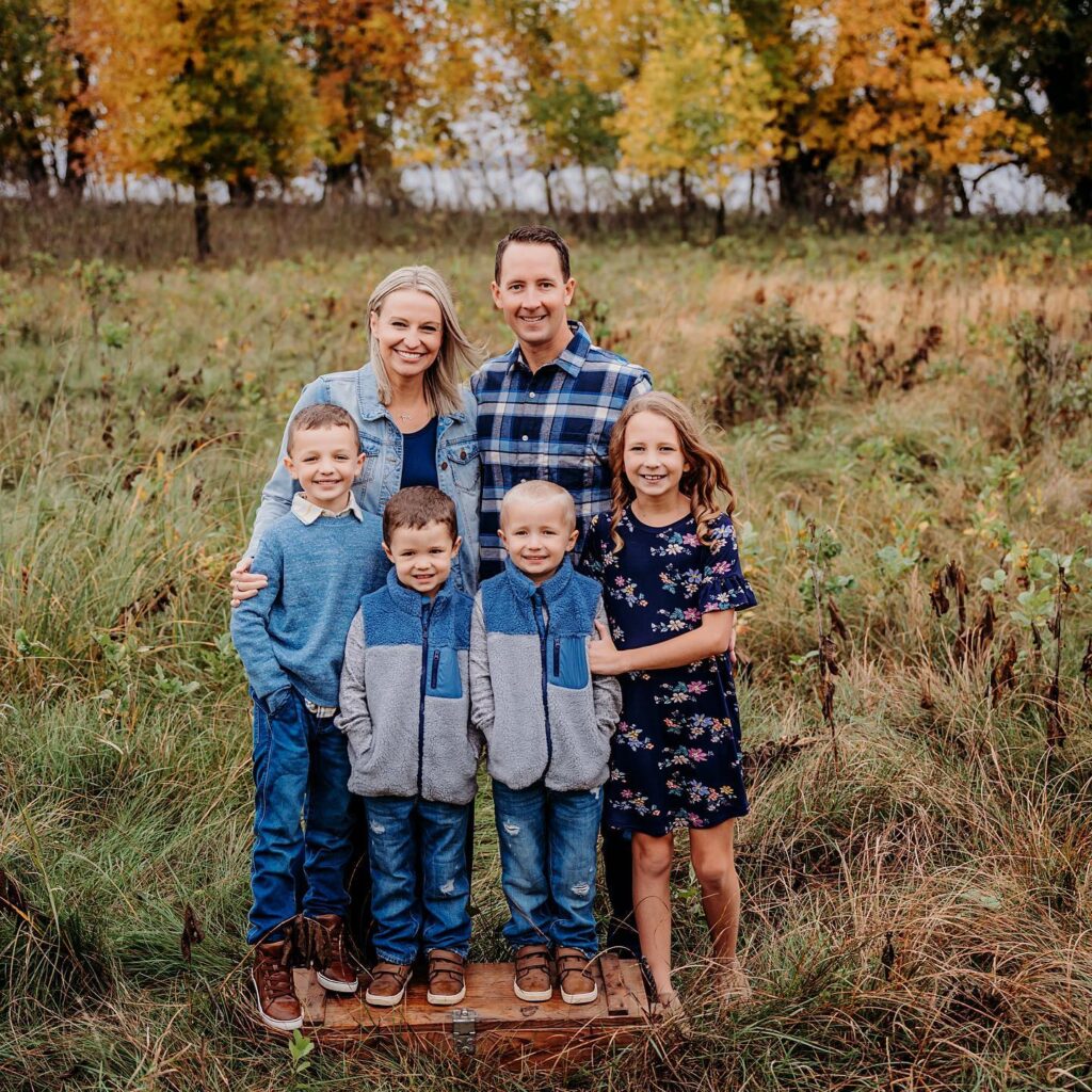 Family of six in a blue field, all shades of blue