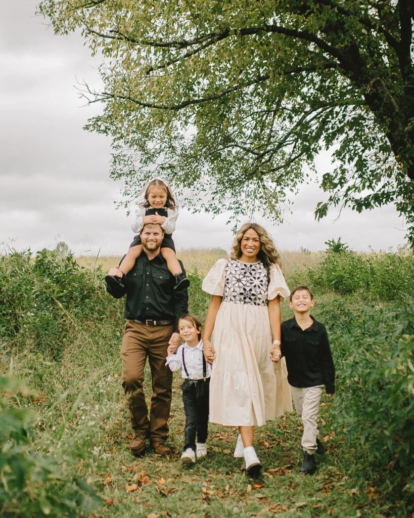 Family of five in a field, mom in cream with floral bodice