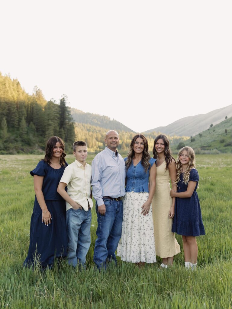 Family of six in a green meadow, navy and butter yellow