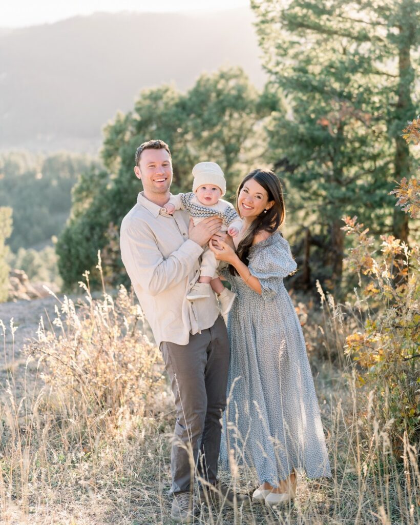 Couple and baby in the mountains, mom in dusty blue floral